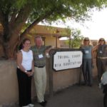 Cathy Bennett, Peter Loomis, Chris Traskos, and Ruth Kraft in front of the Tribal Court building at Pueblo de San Ildefonso